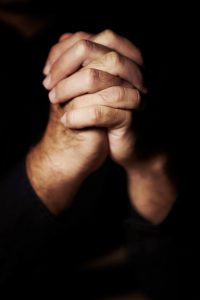 Hands clasped in prayer