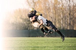 Two American football players in action. [fusion_builder_container hundred_percent=